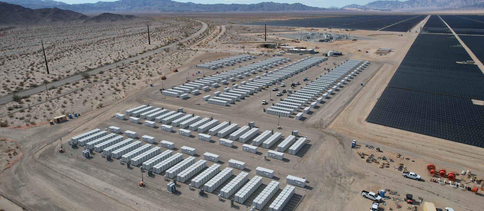 Containere de baterii ale unei instalații de stocare a energiei, în deșert, sub cer senin