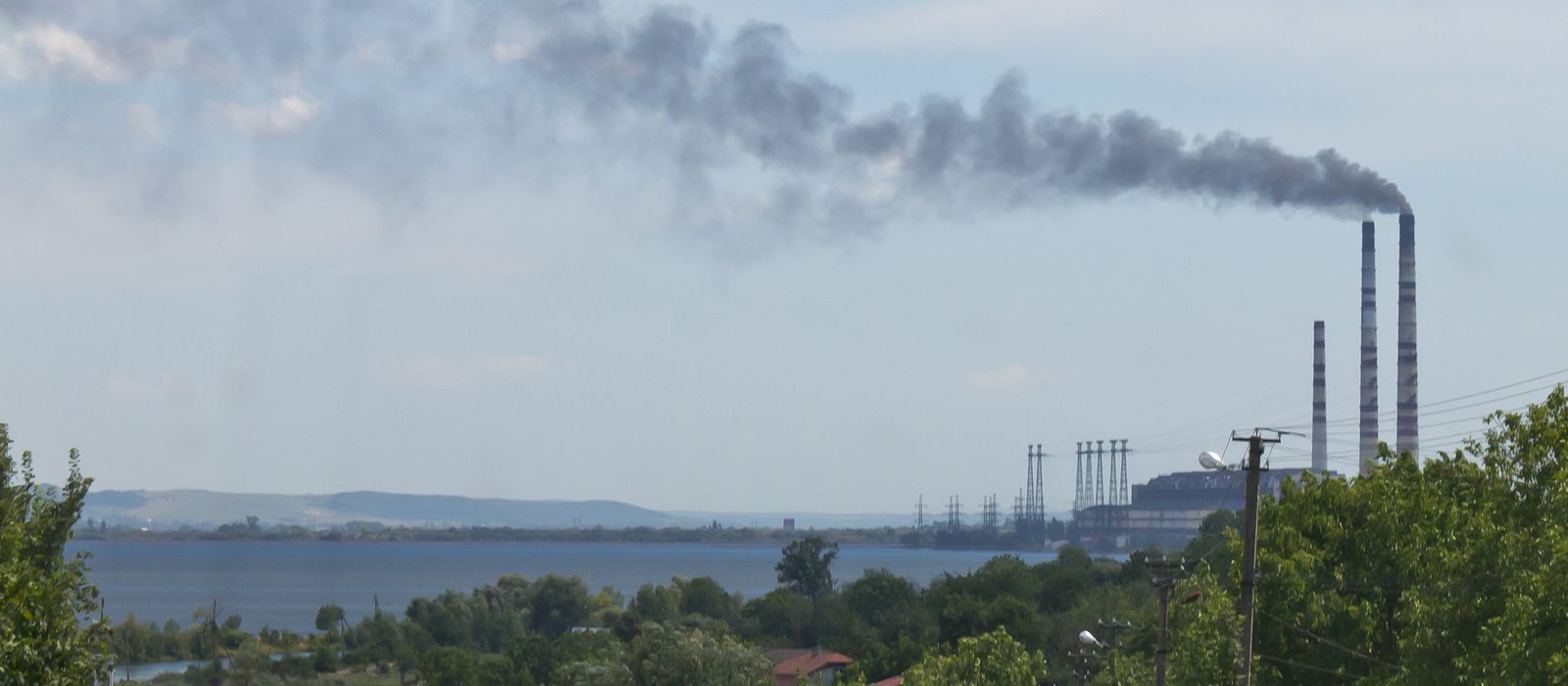 Termocentrala Burshtyn din Ucraina, cu coșuri industriale ce emit fum, la nodul unde rețeaua electrică se leagă de România, Ungaria și Slovacia